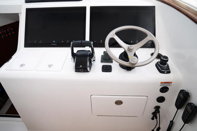 Slide: The Image of Control panel of 2026 Front Runner 47WA boat with dual screens and steering wheel. - 35