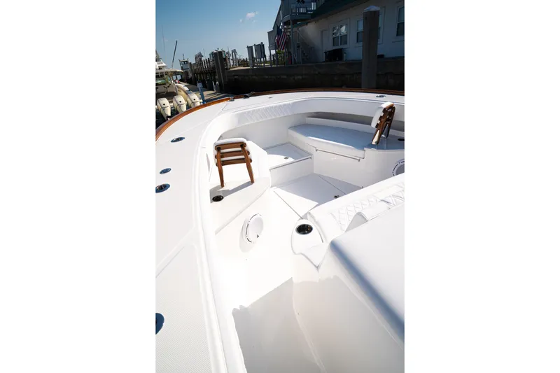 Slide: The Image of Front Runner 47WA 2026 boat with spacious white deck and seating area. - 8