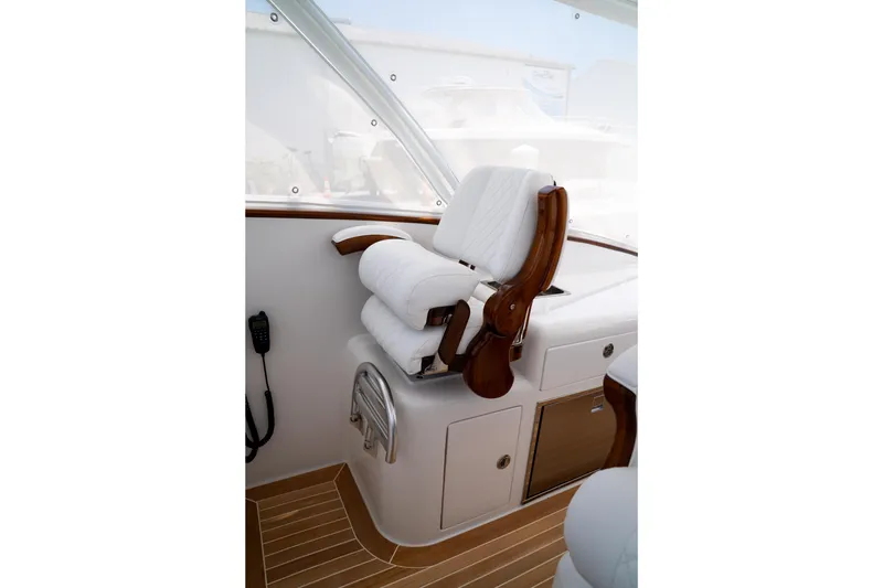 Slide: The Image of Captain's chair on 2026 Front Runner 47WA boat, featuring luxurious white upholstery and wooden accents. - 9