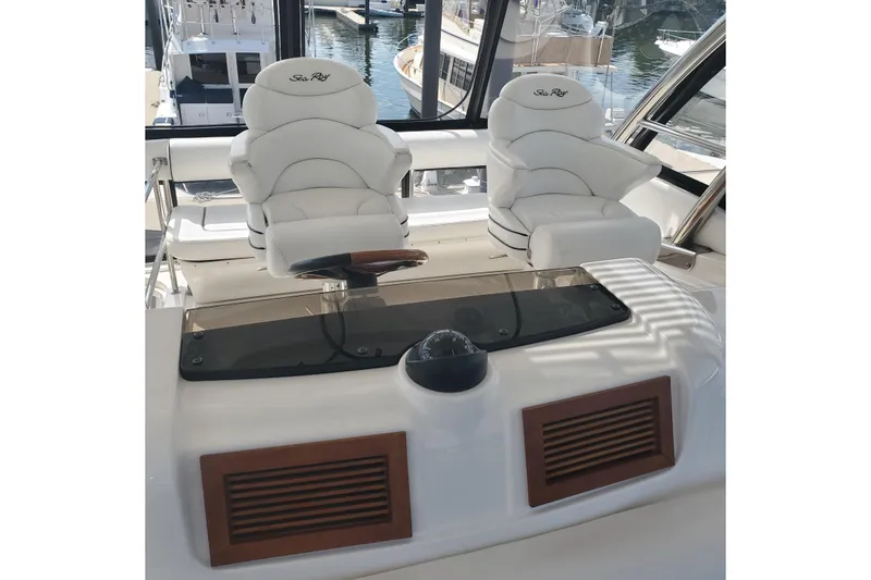 Slide: The Image of 2007 Sea Ray 580 Sedan Bridge helm with luxurious white captain chairs. - 11