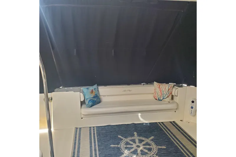 Slide: The Image of 2007 Sea Ray 580 Sedan Bridge interior with nautical-themed decor and cushions. - 12