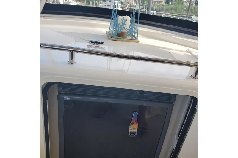 Slide: The Image of 2007 Sea Ray 580 Sedan Bridge interior with mini fridge and decorative candle holder. - 15