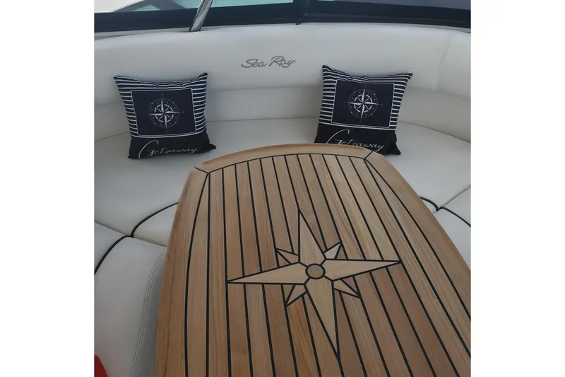 Slide: The Image of Luxurious 2007 Sea Ray 580 Sedan Bridge interior with elegant wood table and nautical pillows. - 18