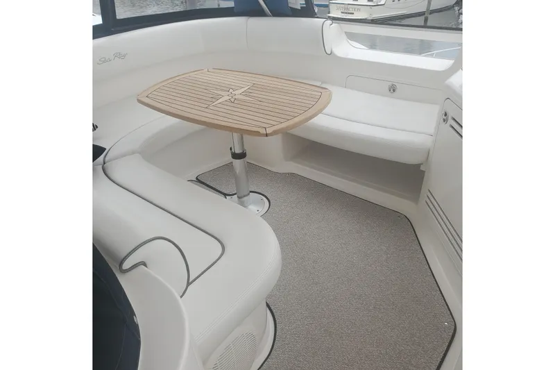 Slide: The Image of 2007 Sea Ray 580 Sedan Bridge interior with elegant seating and wooden table. - 19