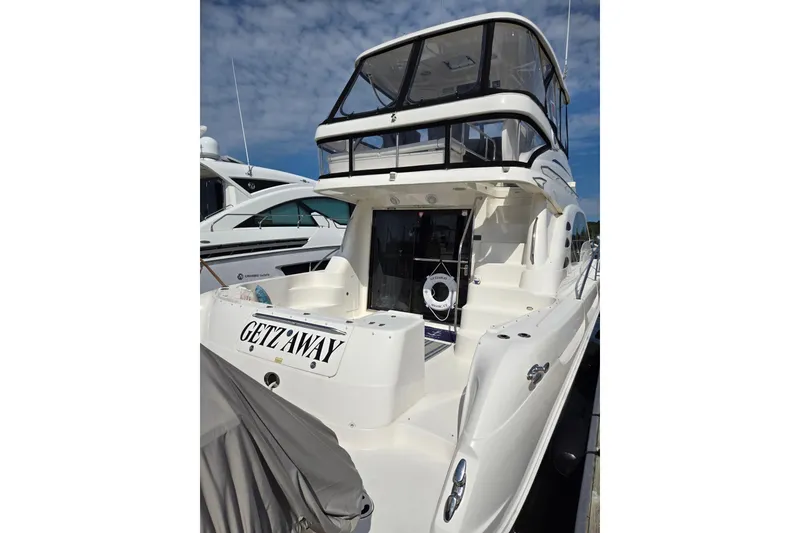 Slide: The Image of 2007 Sea Ray 580 Sedan Bridge yacht docked, featuring spacious deck and sleek design. - 2