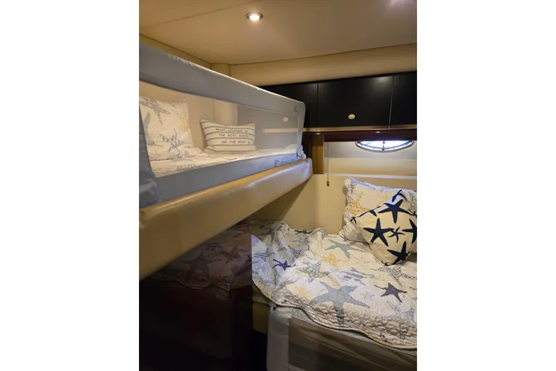 Slide: The Image of 2007 Sea Ray 580 Sedan Bridge cabin with cozy bunk beds and starfish-themed bedding. - 21