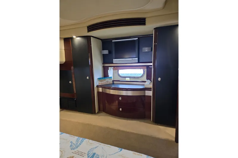Slide: The Image of Luxurious interior of 2007 Sea Ray 580 Sedan Bridge yacht with elegant cabinetry and window view. - 24