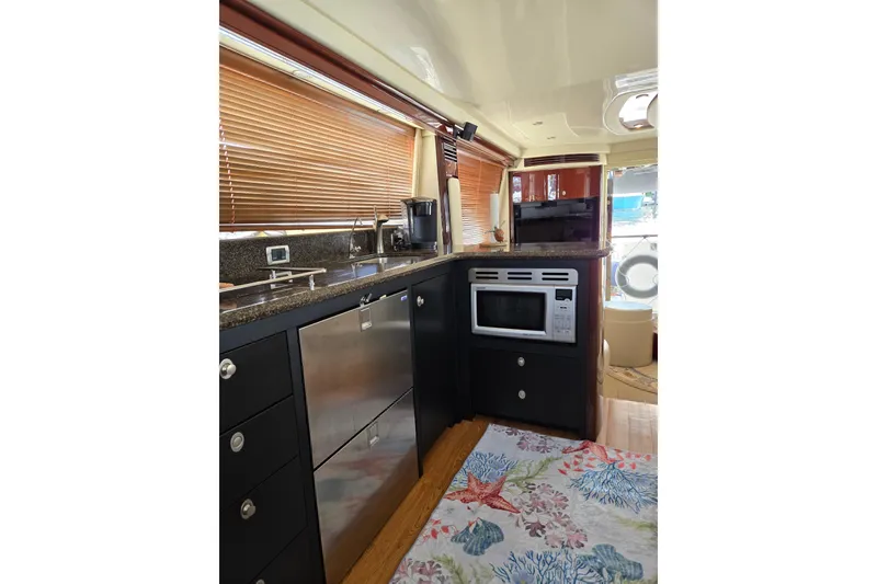 Slide: The Image of Luxurious 2007 Sea Ray 580 Sedan Bridge yacht kitchen with modern appliances and elegant design. - 26