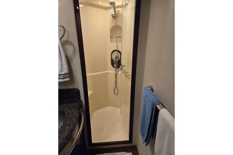 Slide: The Image of Shower area in 2007 Sea Ray 580 Sedan Bridge yacht bathroom with towels. - 31