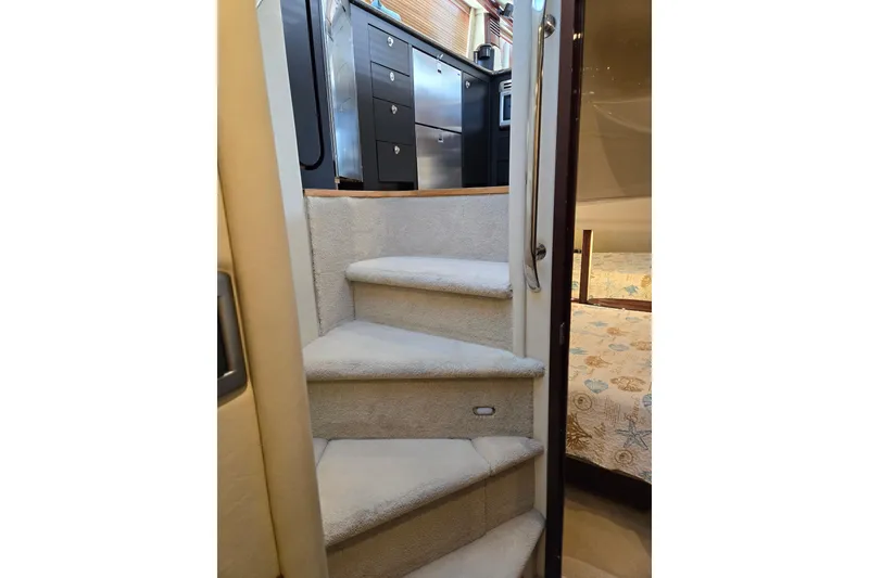 Slide: The Image of Interior stairs of 2007 Sea Ray 580 Sedan Bridge yacht, leading to kitchen and bedroom. - 33