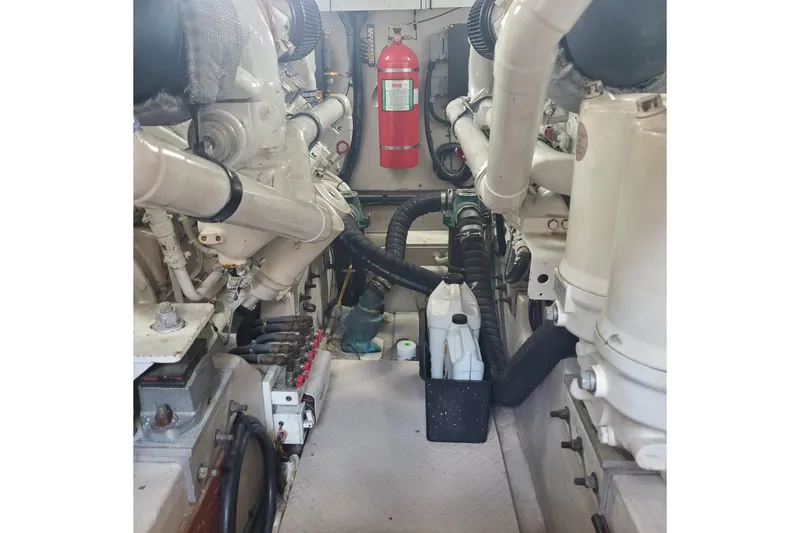 Slide: The Image of Engine room of 2007 Sea Ray 580 Sedan Bridge with visible fire extinguisher and machinery. - 7
