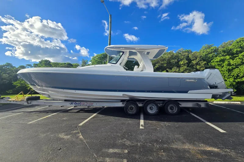 Slide: The Image of 2025 Intrepid 41 Panacea boat on trailer under blue sky and clouds. - 0