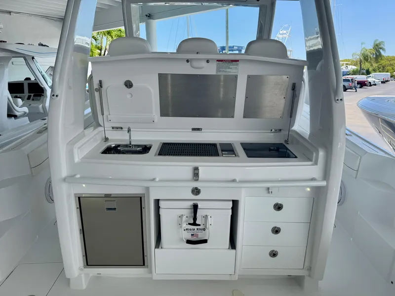 Slide: The Image of 2025 Intrepid 41 Panacea boat galley with sink, storage, and modern amenities. - 10