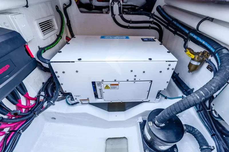 Slide: The Image of Engine room of 2025 Intrepid 41 Panacea boat, featuring advanced mechanical systems and wiring. - 17