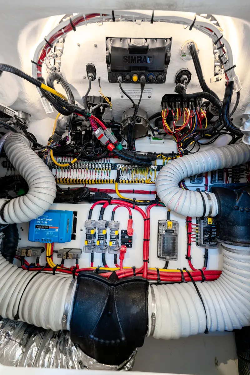 Slide: The Image of Engine compartment of 2025 Intrepid 41 Panacea, showcasing wiring and components. - 18