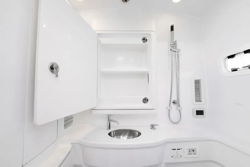 Slide: The Image of 2025 Intrepid 41 Panacea boat bathroom with sleek white design and modern fixtures. - 24