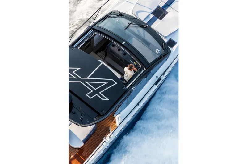 Slide: The Image of 2026 Beneteau Gran Turismo 40 yacht on serene ocean at sunset. - 16