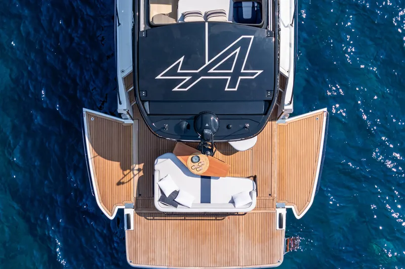 Slide: The Image of Aerial view of 2026 Beneteau Gran Turismo 40 yacht with vibrant blue underwater lights. - 20