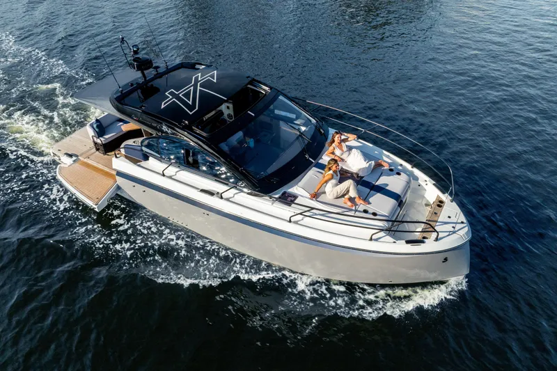 Slide: The Image of 2026 Beneteau Gran Turismo 40 cruising on water with passengers relaxing on deck. - 30