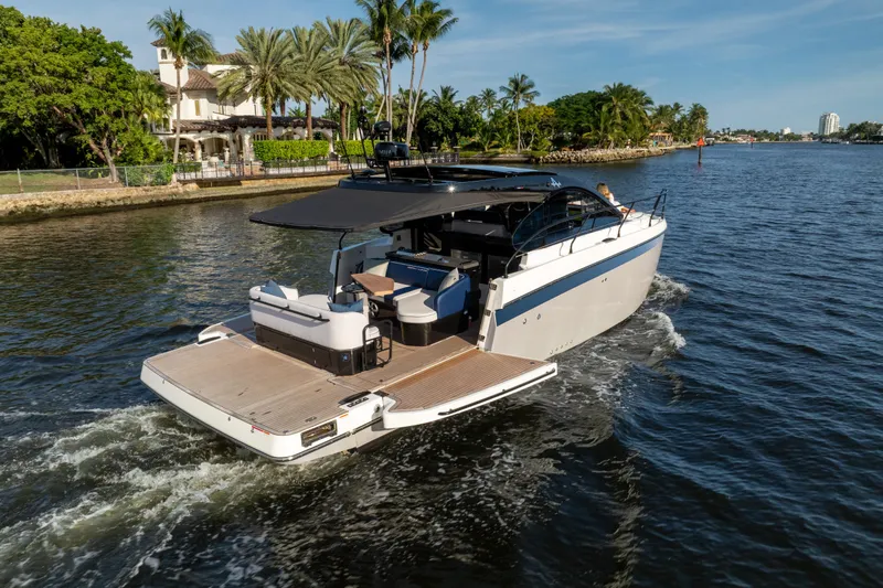 Slide: The Image of 2026 Beneteau Gran Turismo 40 yacht cruising on a scenic waterway. - 34