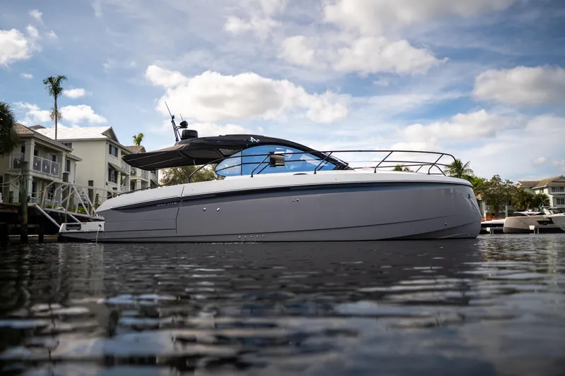 Slide: The Image of 2026 Beneteau Gran Turismo 40 yacht on calm water, modern design, under a partly cloudy sky. - 35