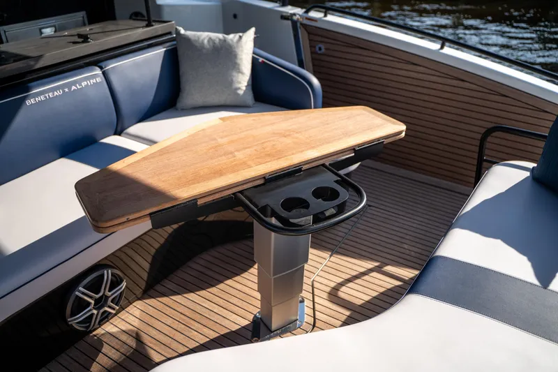 Slide: The Image of Luxury seating area on 2026 Beneteau Gran Turismo 40 yacht with wooden table and cup holders. - 41
