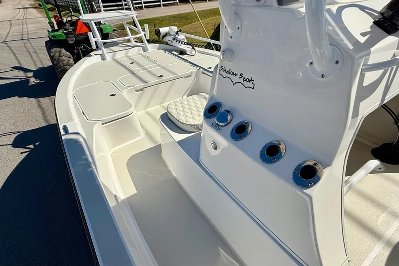 Slide: The Image of 2024 Shallow Sport 24 Modified V boat interior with console and seating. - 12