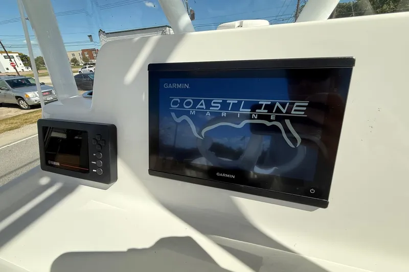 Slide: The Image of 2024 Shallow Sport 24 Modified V boat dashboard with Garmin and Yamaha displays. - 16