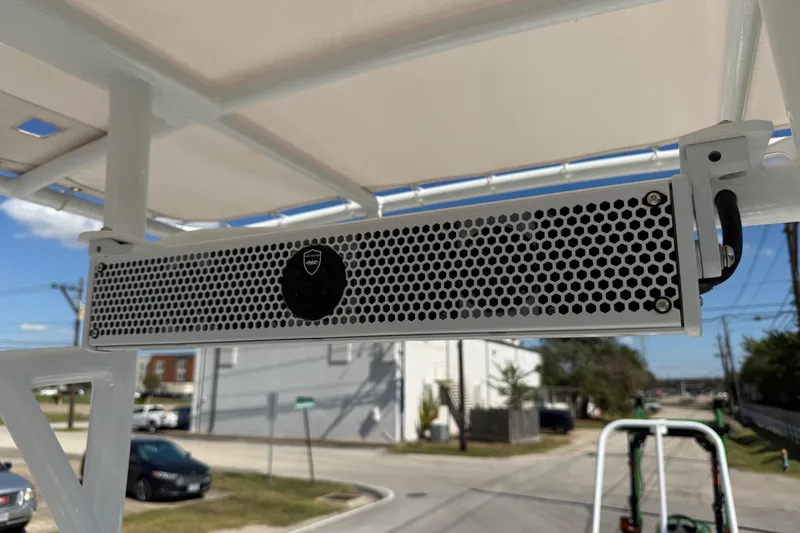 Slide: The Image of 2024 Shallow Sport 24 Modified V boat speaker system under canopy. - 18