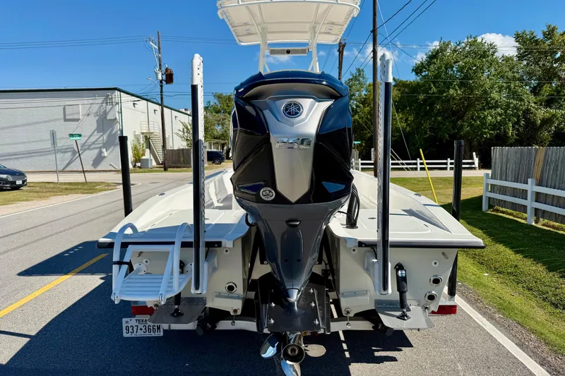 Slide: The Image of 2024 Shallow Sport 24 Modified V boat with powerful outboard motor on a sunny street. - 3