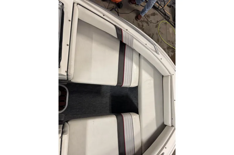 Slide: The Image of 1993 Sea Ray 170 Bow Rider interior with white seating and striped accents. - 11