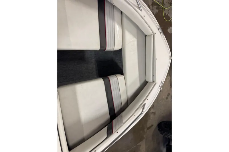 Slide: The Image of 1993 Sea Ray 170 Bow Rider interior with white seating and red accents. - 12