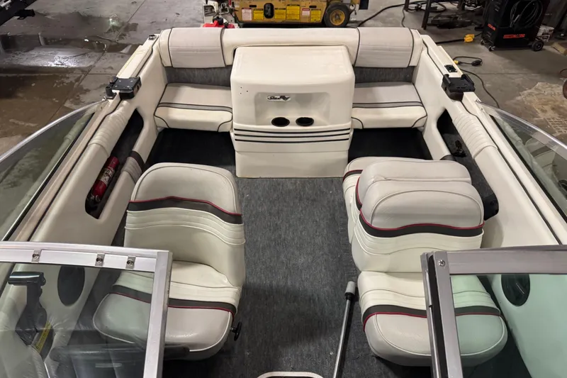 Slide: The Image of 1993 Sea Ray 170 Bow Rider interior with white seating and gray carpet. - 13