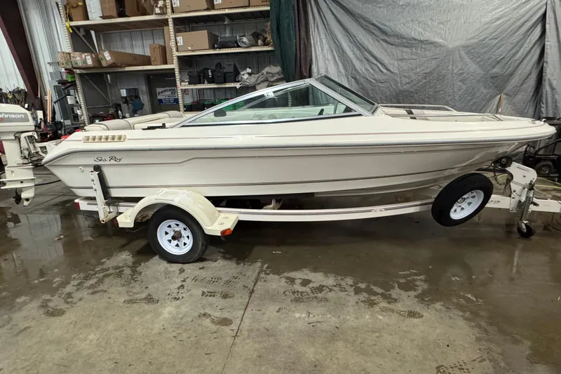 Slide: The Image of 1993 Sea Ray 170 Bow Rider boat on trailer in a garage setting. - 3
