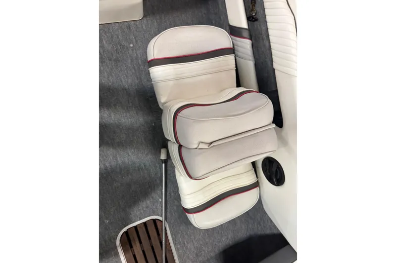 Slide: The Image of 1993 Sea Ray 170 Bow Rider interior with white and red-striped seating. - 7