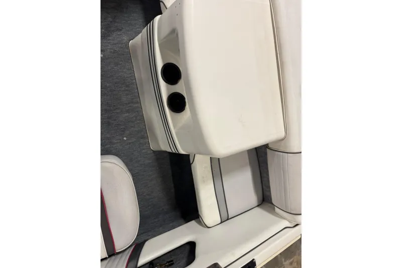 Slide: The Image of 1993 Sea Ray 170 Bow Rider interior with white seating and cup holders. - 8