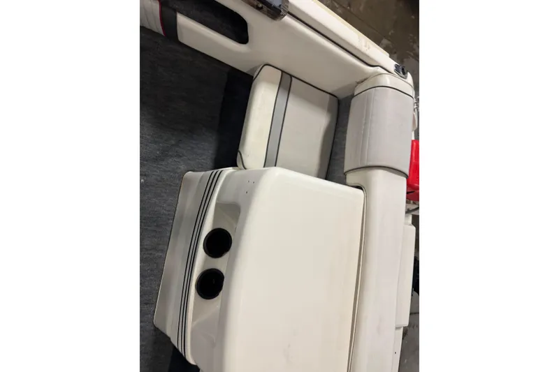 Slide: The Image of 1993 Sea Ray 170 Bow Rider interior seating with cup holders and upholstery details. - 9