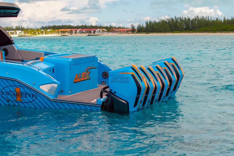 Slide: The Image of 2025 Cigarette 52 Thunder boat with multiple engines in turquoise water near a tropical beach. - 3