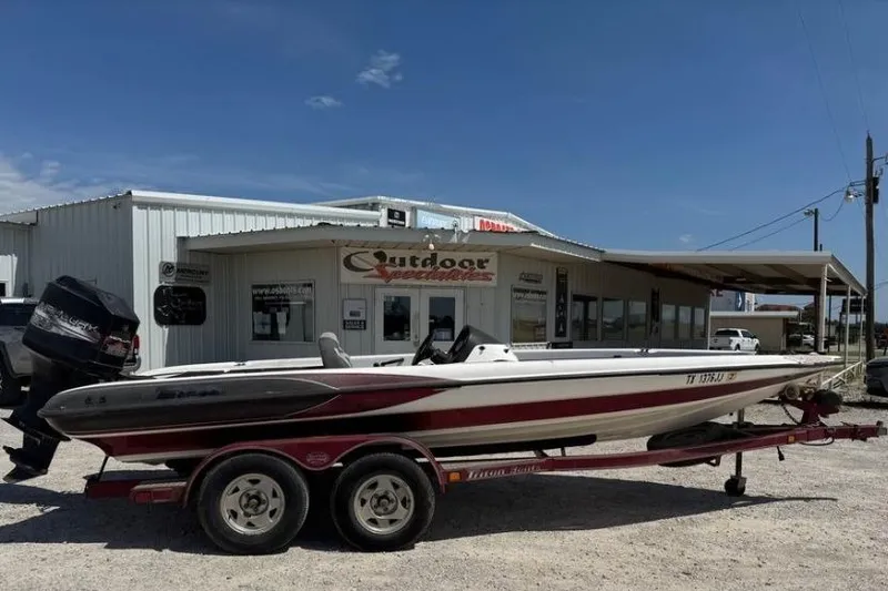 Slide: The Image of 2000 Triton TR-21 boat on trailer outside Outdoor Specialties store. - 1