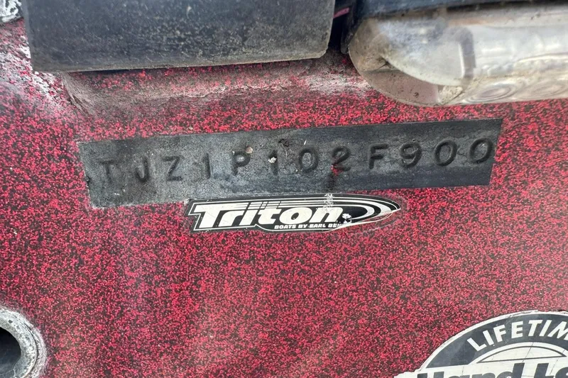 Slide: The Image of Close-up of a 2000 Triton TR-21 boat hull identification number and logo. - 10