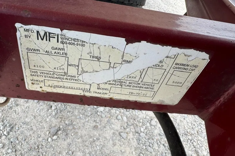 Slide: The Image of Damaged label on a 2000 Triton TR-21 trailer showing vehicle specifications. - 12