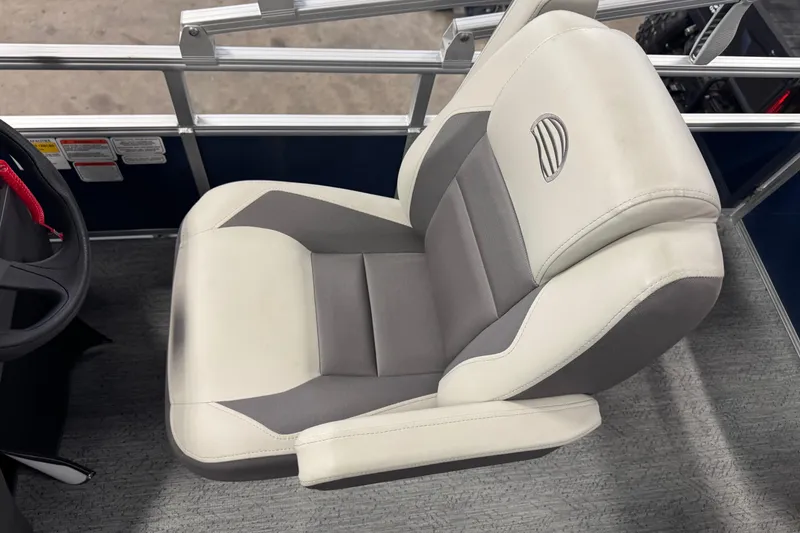 Slide: The Image of 2026 Sun Tracker Bass Buggy 18 DLX boat seat, gray and white design, steering wheel visible. - 12