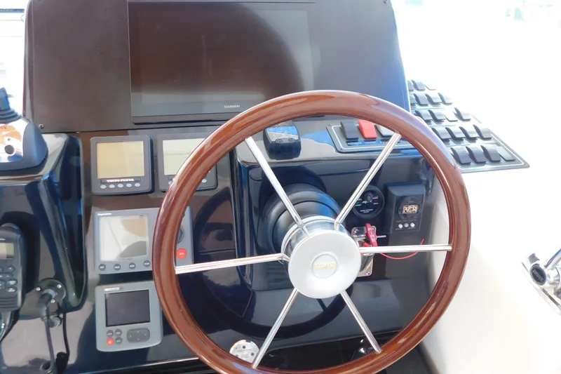Slide: The Image of Helm of 2009 Tiara Yachts 4300 Sovran with wooden steering wheel and navigation instruments. - 18