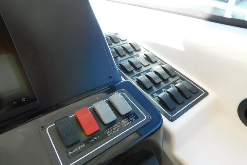 Slide: The Image of Control panel of a 2009 Tiara Yachts 4300 Sovran, featuring switches and buttons. - 19