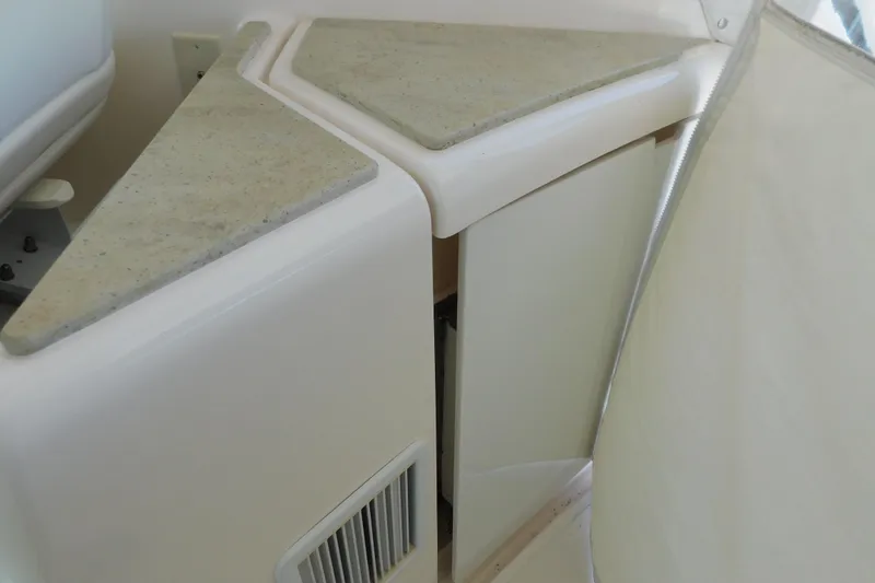 Slide: The Image of Interior detail of 2009 Tiara Yachts 4300 Sovran, featuring a corner cabinet with beige countertop. - 23
