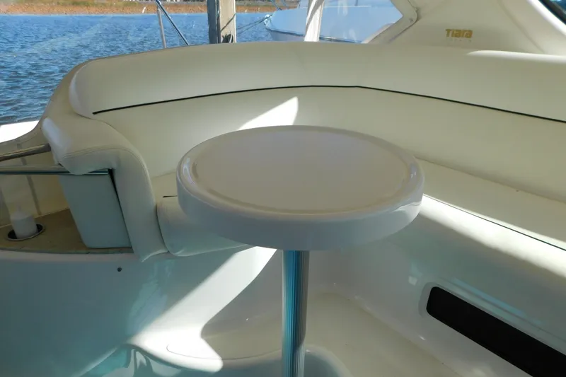 Slide: The Image of 2009 Tiara Yachts 4300 Sovran interior with white seating and table, overlooking water. - 28