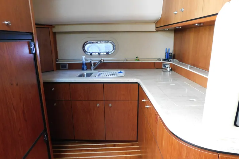 Slide: The Image of Luxurious 2009 Tiara Yachts 4300 Sovran kitchen with wood cabinetry and modern amenities. - 33