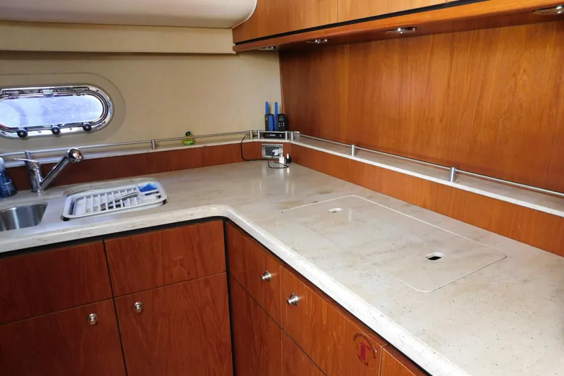 Slide: The Image of 2009 Tiara Yachts 4300 Sovran kitchen with wooden cabinets and sleek countertop. - 34