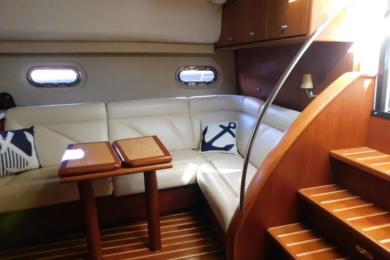 Slide: The Image of 2009 Tiara Yachts 4300 Sovran interior with white leather seating and nautical decor. - 41