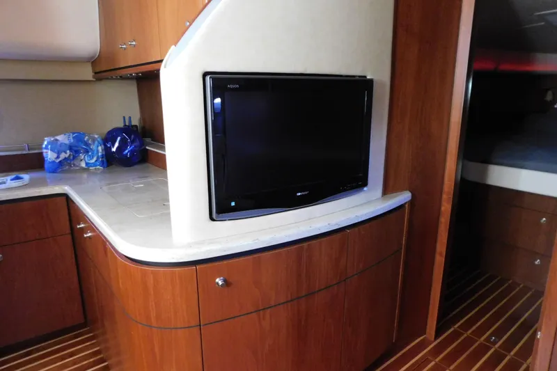 Slide: The Image of 2009 Tiara Yachts 4300 Sovran interior with TV and wooden cabinetry. - 43